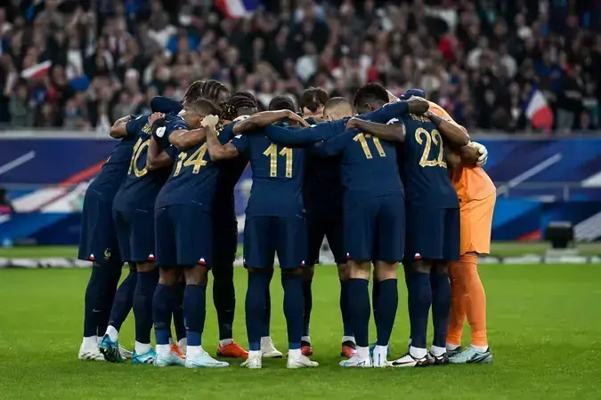 France national team tactical huddle before a World Cup 2026 match